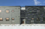 Discover modern living at Norfino Design Apartment, featuring a striking exterior with a unique blend of grey and green tiled facades.