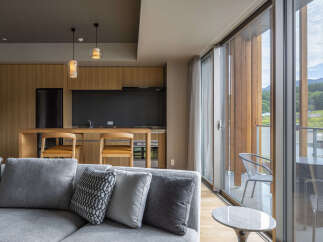 Experience modern living in this stylish apartment featuring a sleek kitchen with ample cabinetry and a breakfast bar.