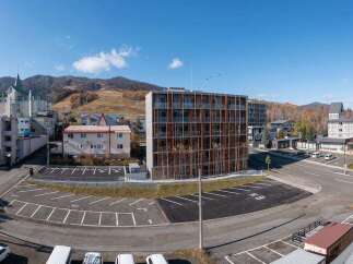 Discover this modern apartment building nestled in a scenic mountain town, offering a unique blend of contemporary design and natural beauty.