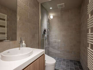 Experience modern comfort in this well-appointed bathroom, featuring a sleek vanity with an integrated sink and a stylish chrome faucet.