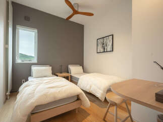 This charming bedroom features two comfortable twin beds, perfect for accommodating guests or family.