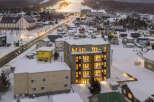 Experience the charm of a winter wonderland from this stunning property, nestled in a snow-covered town.