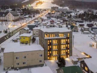 Experience the charm of a winter wonderland from this stunning property, nestled in a snow-covered town.