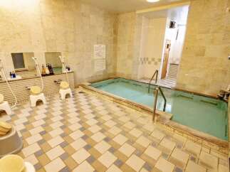 Experience ultimate relaxation in this serene Japanese-style bathing area, featuring a tranquil indoor pool perfect for unwinding.