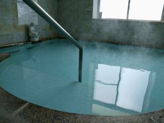 Immerse yourself in relaxation in this inviting indoor hot spring bath, perfect for unwinding after a long day.