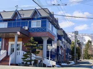 Experience the charm of this blue chalet-style property, perfect for a mountain getaway.