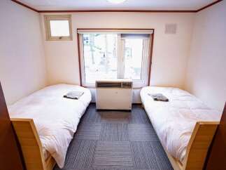 This cozy room features two twin beds, perfect for accommodating guests or family.