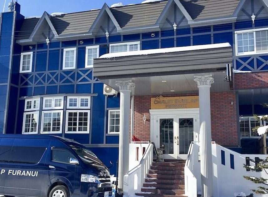 Experience the charm of this stunning blue chalet, perfect for a winter getaway.