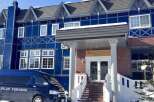 Experience the charm of this stunning blue chalet, perfect for a winter getaway.