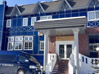 Experience the charm of this stunning blue chalet, perfect for a winter getaway.