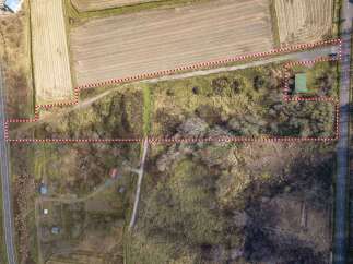 Discover this expansive property featuring a mix of agricultural fields and natural terrain, ideal for development or agricultural pursuits.