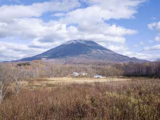 Discover a serene retreat nestled against the majestic backdrop of a snow-capped mountain.