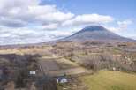 Discover this stunning property nestled in a serene rural landscape, offering breathtaking views of a majestic mountain.