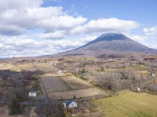 Discover this stunning property nestled in a serene rural landscape, offering breathtaking views of a majestic mountain.