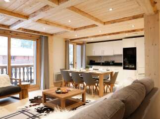 Experience luxurious mountain living in this stunning open-plan living space, featuring a modern kitchen with sleek cabinetry and integrated appliances.