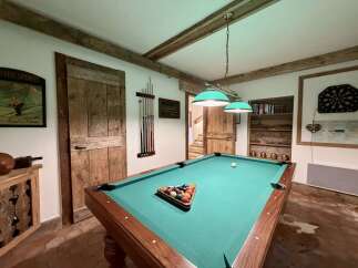 Step into this charming game room, perfect for entertaining guests or enjoying a night in.
