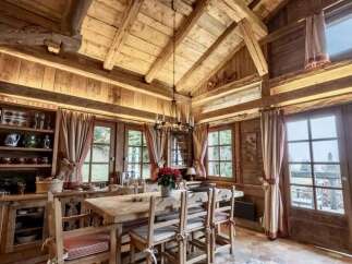 Experience rustic charm in this cozy dining area, featuring a solid wood table and chairs perfect for intimate gatherings.
