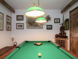 Step into this charming game room, perfect for entertaining guests or enjoying a relaxing evening.