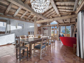 Experience rustic charm in this spacious dining area, featuring a large wooden table perfect for family gatherings.