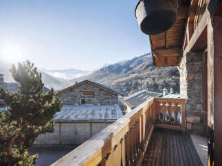 Experience breathtaking mountain views from this charming chalet's balcony, perfect for enjoying crisp alpine air.