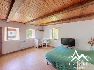Discover this charming room featuring a rustic wooden beamed ceiling and warm hardwood floors.