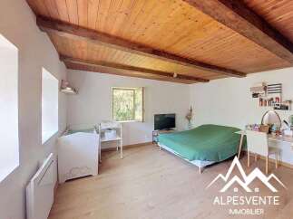 Discover this charming bedroom featuring a cozy crib and a comfortable bed, perfect for a family.