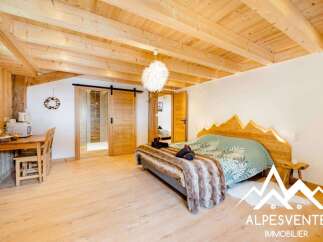 Experience cozy mountain living in this charming studio apartment, featuring a rustic wooden interior and a modern en-suite bathroom.