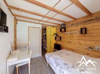 Discover this charming bedroom featuring a cozy bed with a nature-inspired duvet, perfect for relaxation.