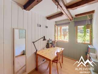 Discover this charming room featuring a wooden desk with a task lamp, perfect for a home office or study area.