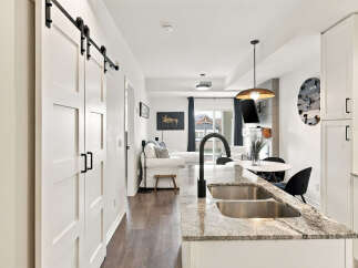 Experience modern living in this stunning home featuring sleek barn doors and a spacious open-concept layout.
