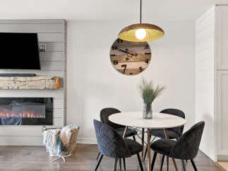 Cozy living room featuring a modern electric fireplace with a rustic wood mantel and a large flat-screen TV above.