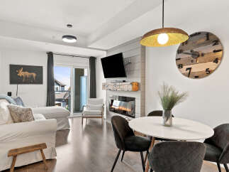 Experience modern living in this stylish condo featuring a cozy fireplace and a sleek dining area perfect for entertaining.