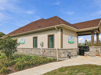 Discover The View Recreation Centre, a modern facility featuring a stone and siding exterior under a brown shingle roof.