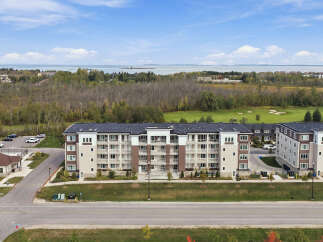 Experience modern living in this stunning multi-story apartment complex, featuring a contemporary facade with brick and beige accents.