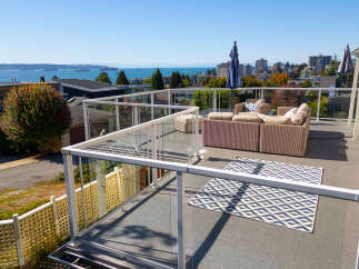 Enjoy breathtaking ocean and city views from this expansive rooftop patio, perfect for entertaining or relaxing.