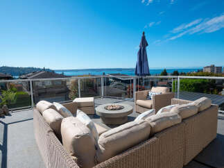 Enjoy breathtaking panoramic views from this stunning rooftop patio, perfect for entertaining or relaxing.