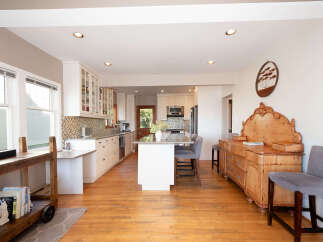 This spacious kitchen and dining area features a large island with seating, perfect for casual meals or entertaining guests.