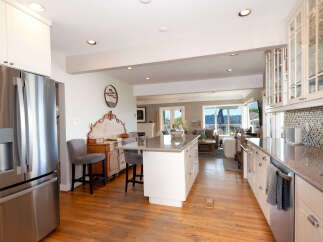 This spacious kitchen boasts a large island with seating, perfect for casual dining or entertaining.