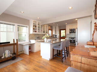This spacious kitchen boasts a large island with seating, perfect for casual dining and entertaining.