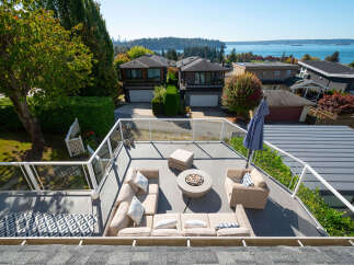 Enjoy breathtaking views from this stunning rooftop patio, perfect for entertaining or relaxing.