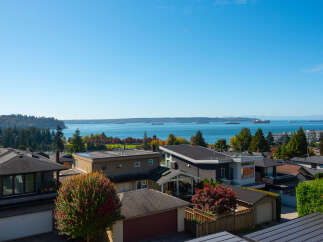 Experience breathtaking panoramic views of the water and distant mountains from this stunning property.