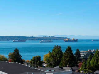 Experience breathtaking waterfront living with stunning views of active shipping lanes and distant mountains.