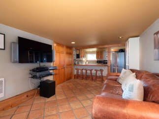 Experience comfortable living in this inviting space featuring a plush leather sofa perfect for relaxation.