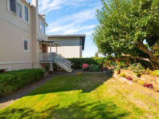 Discover this charming property featuring a spacious backyard perfect for outdoor entertaining, complete with a tiered garden and mature trees.