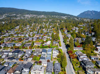 Discover this stunning residential neighborhood nestled against a backdrop of lush green mountains.