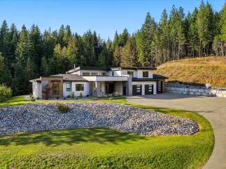 Discover modern luxury in this stunning contemporary home nestled amidst a serene forest backdrop.