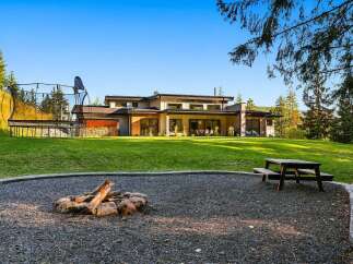 Experience luxury outdoor living with this stunning modern home featuring a spacious backyard perfect for entertaining.