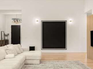 Experience modern living in this spacious entryway, featuring a striking black abstract artwork as a focal point.