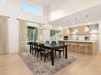 Experience modern living in this stunning open-concept space, featuring a spacious dining area with a dark wood table and chairs, perfect for family gatherings.