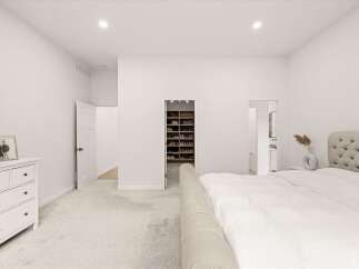 Experience luxury and organization in this spacious master bedroom, featuring a walk-in closet with ample shelving for all your footwear.